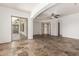 Spacious living room featuring tiled flooring and access to a sunroom, perfect for entertaining at 915 W Orchard Ln, Litchfield Park, AZ 85340