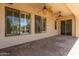 Covered patio featuring dual ceiling fans, brick flooring, and sliding door access to the interior at 915 W Orchard Ln, Litchfield Park, AZ 85340