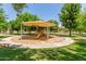Community park offers a covered playground with a slide and benches at 915 W Orchard Ln, Litchfield Park, AZ 85340