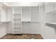Spacious walk-in closet with extensive shelving, providing ample storage and organization options at 915 W Orchard Ln, Litchfield Park, AZ 85340