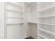 Well-organized walk-in closet with extensive built-in shelving, maximizing storage and functionality at 915 W Orchard Ln, Litchfield Park, AZ 85340