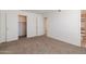 Bedroom features neutral walls, carpet flooring, closet with open doors, and an adjacent bathroom entrance at 925 S Longmore -- # 201, Mesa, AZ 85202