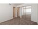 Bedroom features neutral walls, carpet flooring, and closet with mirrored doors at 925 S Longmore -- # 201, Mesa, AZ 85202