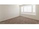 Bedroom featuring neutral walls, carpet flooring, and large windows for ample natural light at 925 S Longmore -- # 201, Mesa, AZ 85202