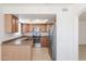 Well-lit kitchen featuring stainless steel appliances, wood cabinets and a skylight at 925 S Longmore -- # 201, Mesa, AZ 85202