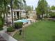 Inviting community pool surrounded by lush landscaping and lounge chairs at 925 S Longmore -- # 201, Mesa, AZ 85202