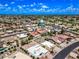Extensive aerial view of a residential community showcasing single-Gathering homes with well-maintained lawns and mature trees at 9654 E Foster Ave, Sun Lakes, AZ 85248