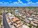 A beautiful aerial shot displays single-Gathering homes, palm trees, and manicured landscaping in a peaceful neighborhood at 9654 E Foster Ave, Sun Lakes, AZ 85248