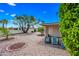 Landscaped backyard with desert landscaping, patio, and blue skies at 9654 E Foster Ave, Sun Lakes, AZ 85248