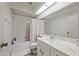 Well lit bathroom features a sink vanity and bathtub with shower at 9654 E Foster Ave, Sun Lakes, AZ 85248