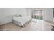 Bedroom with tile floors, a king-size bed, a sliding door, and views of enclosed green space at 9654 E Foster Ave, Sun Lakes, AZ 85248