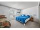 Bedroom with a window letting in natural light and a bed with blue bedding at 9654 E Foster Ave, Sun Lakes, AZ 85248