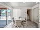 Bright dining area featuring tile floors, a round table with seating for four, and sliding doors leading to the backyard at 9654 E Foster Ave, Sun Lakes, AZ 85248