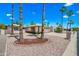 Beautiful front exterior view of single-story home with mature trees, manicured landscape, and a spacious driveway at 9654 E Foster Ave, Sun Lakes, AZ 85248
