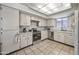 Functional kitchen with white cabinets, modern appliances, and tiled floors, providing a clean and efficient cooking space at 9654 E Foster Ave, Sun Lakes, AZ 85248