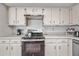 Well-equipped kitchen featuring white cabinets, modern appliances, and ample counter space, ideal for culinary enthusiasts at 9654 E Foster Ave, Sun Lakes, AZ 85248