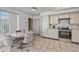 Eat-in kitchen with white cabinets, stainless steel appliances, tile flooring, and a breakfast nook with seating for four at 9654 E Foster Ave, Sun Lakes, AZ 85248