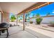 Covered patio with a grill and outdoor seating, perfect for entertaining and relaxation at 9654 E Foster Ave, Sun Lakes, AZ 85248