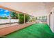 Enclosed sun room with green turf, glass windows overlooking a yard at 9654 E Foster Ave, Sun Lakes, AZ 85248