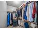 Organized walk-in closet with shelving and clothing racks, offering ample storage space at 9654 E Foster Ave, Sun Lakes, AZ 85248