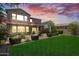 Expansive backyard with green lawn, covered patio, and mature landscaping at 974 W Zion Way, Chandler, AZ 85248