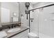 Modern bathroom with herringbone shower tile, floating shelves, and gray vanity with a sink at 974 W Zion Way, Chandler, AZ 85248