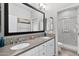 Bright bathroom featuring a double vanity with a modern design, neutral walls, and a glass enclosed shower at 974 W Zion Way, Chandler, AZ 85248