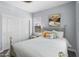 Airy bedroom includes a white bed frame, neutral decor, and a closet with sliding doors at 974 W Zion Way, Chandler, AZ 85248