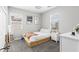 Minimalist bedroom featuring a wooden platform bed, two windows, and a ceiling fan at 974 W Zion Way, Chandler, AZ 85248