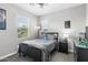 Comfortable bedroom with grey walls, a bed with gray bedding, and natural light from two windows at 974 W Zion Way, Chandler, AZ 85248