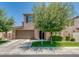 Attractive two-story home showcases a two-car garage, a vibrant lawn, and mature shade trees at 974 W Zion Way, Chandler, AZ 85248