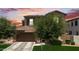 Lovely home boasts a two-car garage, complemented by a well-kept lawn, and mature trees at 974 W Zion Way, Chandler, AZ 85248