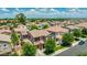 Aerial view of a charming two-story home with a well-maintained lawn and mature trees in a suburban setting at 974 W Zion Way, Chandler, AZ 85248