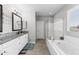 Beautiful bathroom featuring a soaking tub, glass shower, and double vanity at 974 W Zion Way, Chandler, AZ 85248