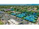 Aerial view of tennis courts, a pool, and beautiful lakes in a well-maintained community with lush landscaping at 974 W Zion Way, Chandler, AZ 85248