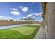 Backyard with a putting green and paved patio at 9845 E Thistle Ave, Mesa, AZ 85212