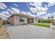 Wide backyard with a putting green, brick pavers, and patio, offering ample space for recreation and entertaining at 9845 E Thistle Ave, Mesa, AZ 85212