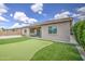 Beautiful backyard featuring a putting green, patio, and lush landscaping, perfect for relaxation and outdoor activities at 9845 E Thistle Ave, Mesa, AZ 85212