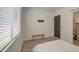 A view of a bedroom with a window and a bench with minimalist decoration at 9845 E Thistle Ave, Mesa, AZ 85212