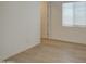 The bedroom is well-lit and features wood-style flooring and neutral walls at 9845 E Thistle Ave, Mesa, AZ 85212