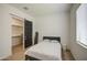 Bright bedroom featuring neutral tones, a modern sliding door, and ample closet space at 9845 E Thistle Ave, Mesa, AZ 85212