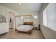 Light-filled primary bedroom boasts a four-poster bed and access to the bathroom at 9845 E Thistle Ave, Mesa, AZ 85212