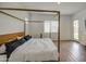 This bedroom has a four-poster bed, light walls, and access to the backyard at 9845 E Thistle Ave, Mesa, AZ 85212