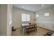 Bright dining area with wooden table, bench, and chairs in a modernly designed, well-lit, and airy home at 9845 E Thistle Ave, Mesa, AZ 85212