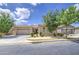 Beautiful one-story home boasts a tile roof, lush landscaping, and a spacious two-car garage at 9845 E Thistle Ave, Mesa, AZ 85212