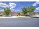 Charming single-story home featuring a tile roof, landscaped front yard, and two-car garage at 9845 E Thistle Ave, Mesa, AZ 85212