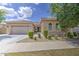 Well-maintained home featuring a tile roof, two-car garage, and nicely manicured desert landscaping at 9845 E Thistle Ave, Mesa, AZ 85212