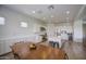 Spacious kitchen featuring a large island, stainless steel appliances, white cabinets, and adjacent dining area at 9845 E Thistle Ave, Mesa, AZ 85212