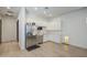 Bright kitchen with white cabinets, stainless steel appliances, and a cozy pet nook at 9845 E Thistle Ave, Mesa, AZ 85212