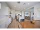 Open-concept kitchen with white cabinetry, stainless steel appliances, an island with seating, and view to the living room at 9845 E Thistle Ave, Mesa, AZ 85212